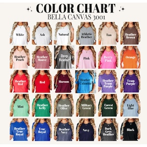 May include: A Bella Canvas 3001 color chart featuring thirty different t-shirt colors arranged in a grid. Each shirt is labeled with its specific color name, including white, ash, natural, heather, tan, brown, peach, mauve, pink, orange, red, maroon, blue, purple, green, and black.