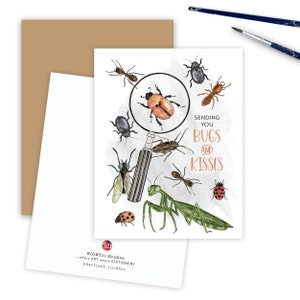 May include: A greeting card with a watercolor illustration of various bugs, including a ladybug, a praying mantis, and a beetle. The card features a magnifying glass over the beetle and the text "Sending you bugs and kisses".