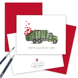 May include: A green garbage truck with red hearts spilling out of the back. The truck is on a white background with the text "HAPPY VALENTINE'S DAY" in green. The card is from eight21 studios, a company based in Grayslake, Illinois.