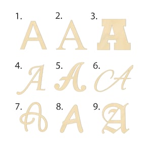 May include: Nine different styles of the letter A, each in a different font. The letter A is made of wood and is painted a light brown color.