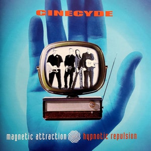 May include: A blue hand holding a vintage television with a band of four people on the screen. The television is playing a video of the band performing. The band is called "Cinecyde" and the album is called "Magnetic Attraction Hypnotic Repulsion".