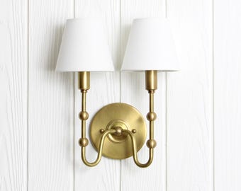 Oyère Dual Wall Sconce -- brass curved arm light fixture lamp linen shade