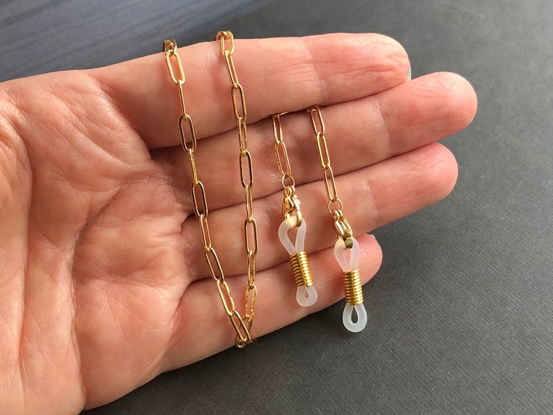 May include: Gold chain with clear silicone ends for glasses.