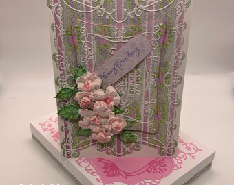 Handmade Birthday card in pinks, violets and greens with exquisite die cut layers featuring handmade wild rose blooms and gift box