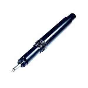 May include: A black pen with a silver nib, angled slightly to the right. The pen has a sleek, cylindrical design with a textured grip near the nib. The pen is set against a white background.
