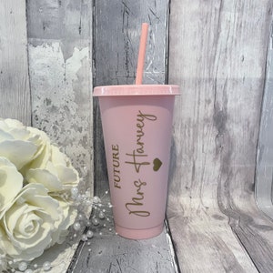 Puede incluir: Vaso reutilizable rosa con una pajita dorada y el texto "Future Mrs Harvey" con un peque&ntilde;o coraz&oacute;n.
