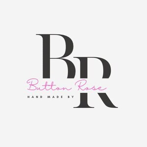 May include: Button Rose logo in black and pink on a white background. The logo features the letters "BR" in a bold, serif font, with "Button Rose" in a cursive script below. The text "HAND MADE BY" is below the cursive text.