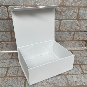 May include: A white cardboard gift box with a hinged lid. The box is open and the inside is empty.