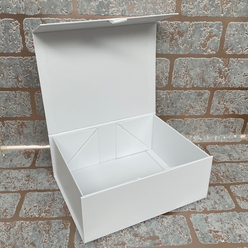 May include: A white cardboard gift box with a hinged lid. The box is open and the inside is empty.