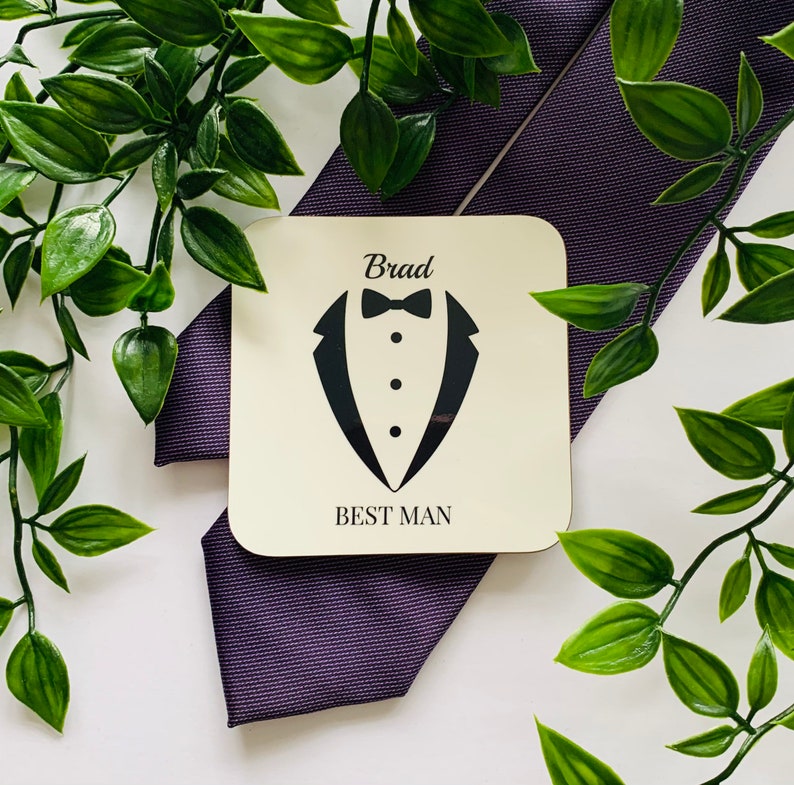 May include: A wooden coaster with a tuxedo design and the text "Brad Best Man".