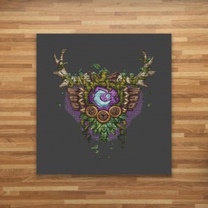 May include: A purple and green embroidered patch with a deer antler design, a moon, and a wooden shield. The patch is surrounded by vines and leaves.