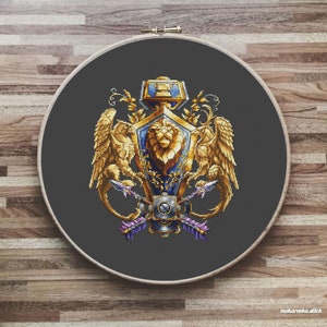 May include: A cross-stitch embroidery of a heraldic crest featuring a lion, two griffins, and a hammer. The crest is surrounded by a wreath of leaves and has a blue and gold color scheme.