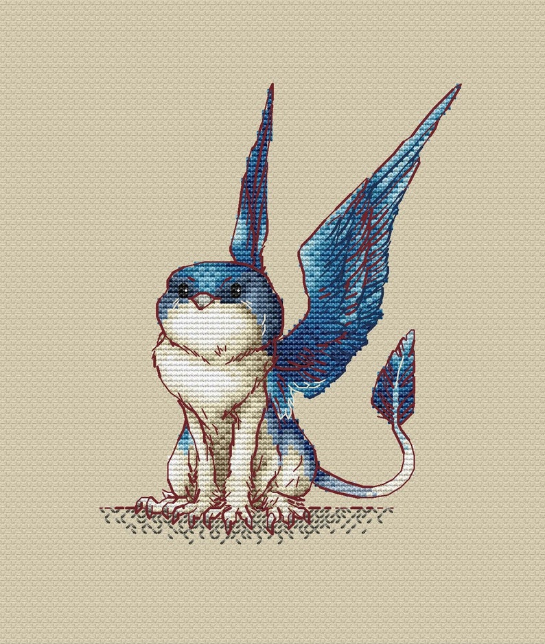 May include: A blue and white cross-stitch pattern of a mythical creature with wings and a tail. The creature has a fluffy white body and blue wings and tail.