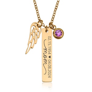 May include: Gold-colored necklace with a pendant that says "mom" in cursive, with dates and a heart symbol. The necklace has a wing charm and a purple gemstone. The chain is also gold-colored.