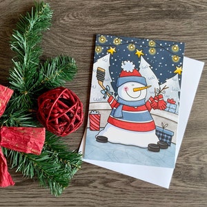 carte de Noel thème de bonhommes neige et de hockey, couleurs vives, hiver