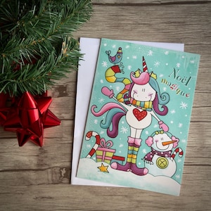 Jolie carte de souhait de Noël avec illustration d’une licorne et d’un bonhomme de neige et avec cadeau.Noël magique.