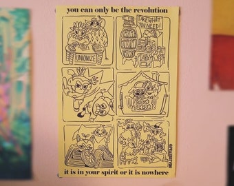 May include: A yellow poster with black line art illustrations and text. The text reads "you can only be the revolution" and "it is in your spirit or it is nowhere." The poster is surrounded by other posters.