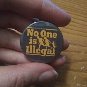 No One is Illegal badge pin button