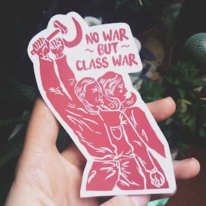 May include: Red and white sticker with a graphic of two people holding a hammer and sickle. The text on the sticker reads "No War ~ But ~ Class War."