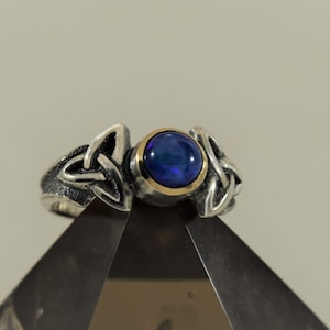 Handmade Silver Ring with two Triquetra Trinity Knots Embracing a 14K Gold Bezel set 6mm Round Cabochon Stone