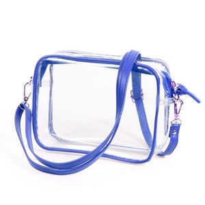 May include: Clear plastic tote bag with a blue trim and a blue adjustable shoulder strap. The bag has a zipper closure.