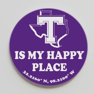 May include: A round purple sticker with white text and graphics. The text reads "IS MY HAPPY PLACE" with coordinates below. A white outline of Texas and a "T" are at the top.
