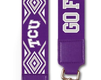 May include: Purple and white patterned lanyard with gold metal clasps. The lanyard features the text "GO FROGS" and "TCU" in white.