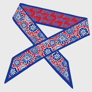 May include: A red, white, and blue floral patterned scarf with the text "pony up" repeated on a red background. The scarf has a blue border and a floral design with white and blue flowers.