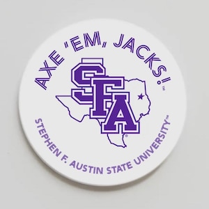 May include: A white, circular coaster with purple text and graphics. The text reads "AXE 'EM, JACKS!" and "STEPHEN F. AUSTIN STATE UNIVERSITY." A purple graphic of the letters "SFA" is centered over a Texas outline.