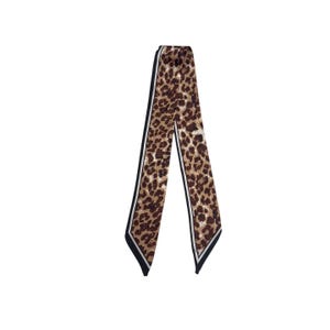 May include: A long, slender scarf with a leopard print pattern. The scarf features a brown and tan spotted design with black and white stripes along the edges. The scarf is made of a soft, flowing material.
