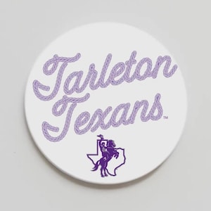 May include: A white circular coaster with the words "Tarleton Texans" in lavender rope-style lettering. A purple graphic of a rider on a horse inside the outline of Texas is below the text. The coaster is a promotional item.