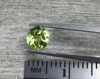 Peridot, one 6mm faceted semiprecious gemstone, light yellow green