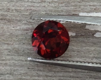 Mozambique red garnet, one 6mm faceted semiprecious gemstone