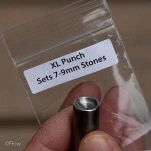May include: A cylindrical metal punch tool with a concave top, designed for setting 7-9mm stones. The tool is packaged in a clear plastic bag with a white label that reads: XL Punch, Sets 7-9mm Stones. The metal surface is smooth and silver-toned.