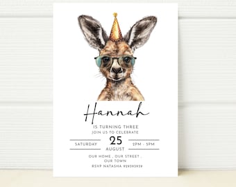 May include: A birthday invitation featuring a cartoon kangaroo wearing sunglasses and a party hat. The invitation says "Hannah is turning three, join us to celebrate. Saturday, August 25, 2PM - 5PM, Our home, our street, our town. RSVP Natasha 929393939."