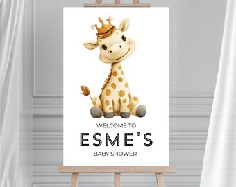 May include: A baby shower sign featuring a smiling giraffe wearing a gold crown. The giraffe has tan spots and is sitting on its bottom. The sign reads "Welcome to Esme's Baby Shower" in black text.