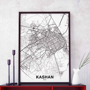 May include: Black and white map print of Kashan, Iran in a black frame. The map shows the city streets and landmarks.