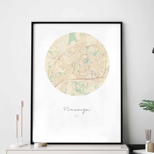 May include: A printable map of Vicenza, Italy, in a circular design with a beige background and brown lines. The city name is written in cursive below the map.