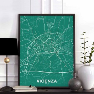 May include: A green and white map print of Vicenza, Italy, in a black frame. The map is a detailed street map of the city.