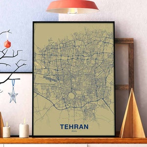 May include: A beige and blue map print of Tehran, Iran, in a black frame. The map shows the city's streets and landmarks. The text "TEHRAN" and "IRAN" is printed below the map.