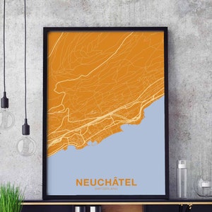 May include: A framed map of Neuchâtel, Switzerland, with a light blue background and orange lines representing streets and roads. The city name is printed in black at the bottom of the map.