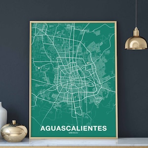 May include: A teal green city map print with white lines showing the streets of Aguascalientes, Mexico. The city name is printed in white at the bottom of the map.