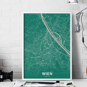 May include: A teal green map print of Vienna, Austria, in a white frame. The map shows the city's streets and waterways. The text "WIEN" and "AUSTRIA" is printed below the map.