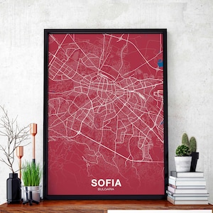 Puede incluir: Un mapa enmarcado de Sofía, Bulgaria, con un fondo rojo y líneas blancas que muestran las calles de la ciudad. El mapa está enmarcado en negro y tiene el nombre de la ciudad y el país impreso en la parte inferior.