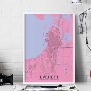 May include: A framed map print of Everett, Washington, in pink and blue. The city's layout is detailed, with streets and waterways visible. The text "EVERETT WASHINGTON, UNITED STATES" is displayed in a clean font at the bottom of the print.