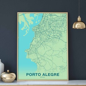 May include: A framed map of Porto Alegre, Brazil, with a light green background and dark blue lines showing the city streets. The city is located on a body of water, which is shown in a light blue color. The text "PORTO ALEGRE" and "BRAZIL" is printed in dark blue at the bottom of the map.