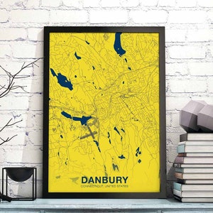 May include: A framed map of Danbury, Connecticut, with a yellow background and blue lines. The city name is printed in blue at the bottom of the map.