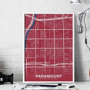 Puede incluir: Una impresión de mapa de ciudad rojo y blanco con el texto "PARAMOUNT, CALIFORNIA, ESTADOS UNIDOS" en la parte inferior. El mapa muestra las calles y carreteras de la ciudad.