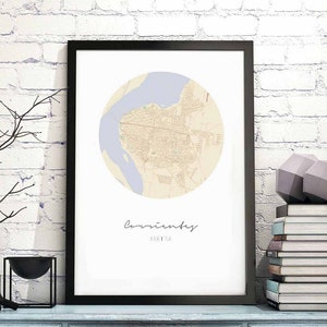 May include: A black framed print with a beige and light blue map of Coventry, Arizona. The map is in a circle with the city name written in cursive below it.