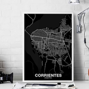 May include: Black and white city map print of Corrientes, Argentina. The map is framed in a white frame and is on a white brick wall.